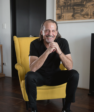 Architect Avner Yashar seated in an armchair