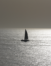 A sailboat on the sea in silhouette
