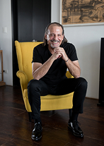 Architect Avner Yashar seated in an armchair