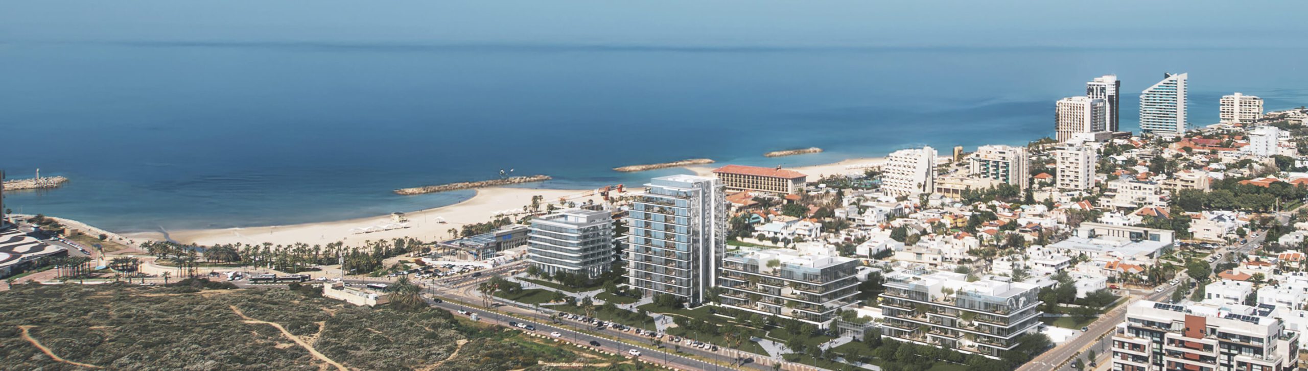 An aerial view of the Herzliya Pituach coastline with the beach and the city skyline